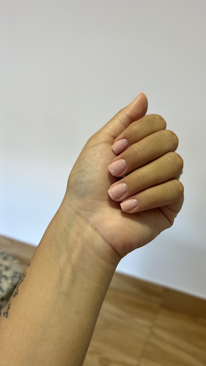 Mano con manicura nude de uñas cortas y acabado natural